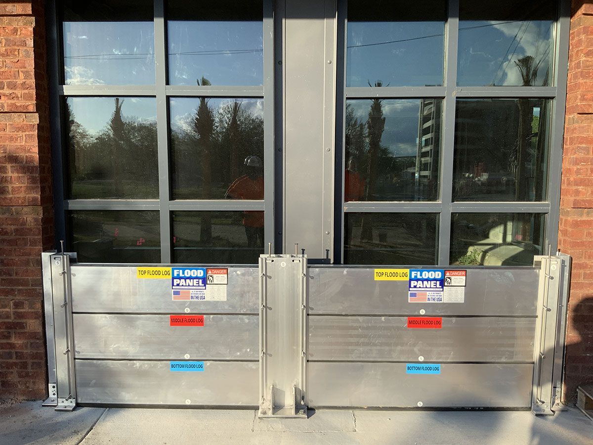 A brick building with a flood barrier in front of it