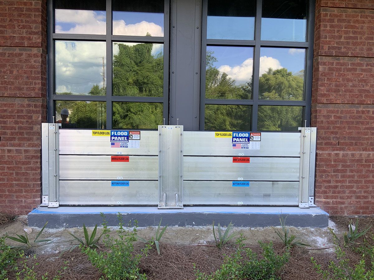 A brick building with flood barriers in front of it