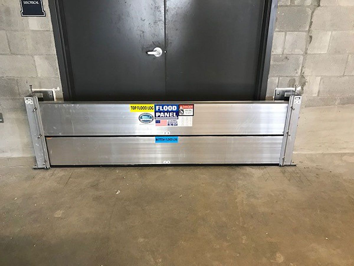 A flood barrier is sitting in front of a door in a building.