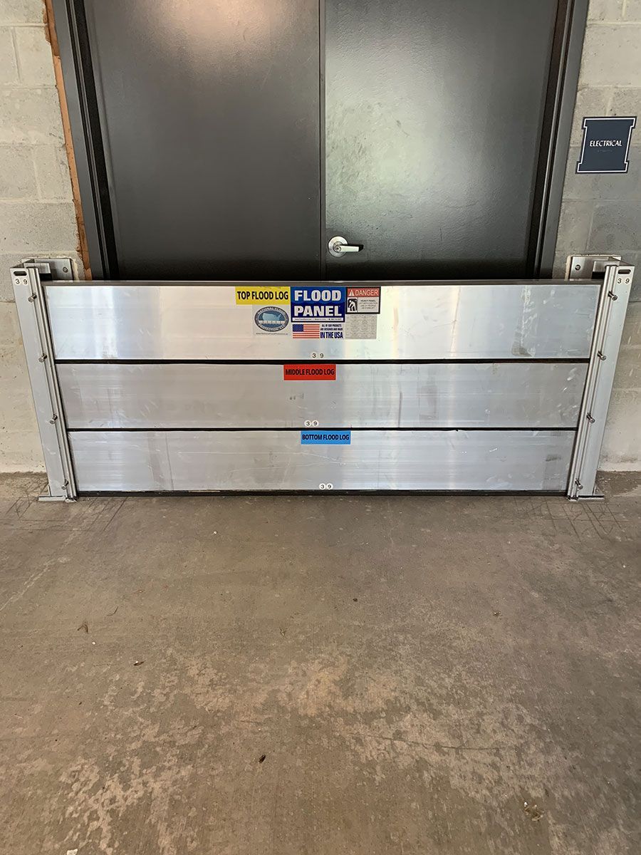 A flood barrier is sitting in front of a door in a building.