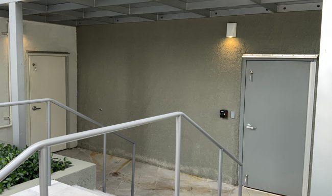 A staircase leading up to a door with a railing.