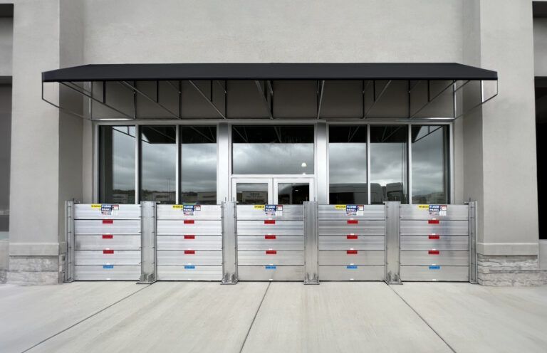 A building with a canopy and flood barriers in front of it