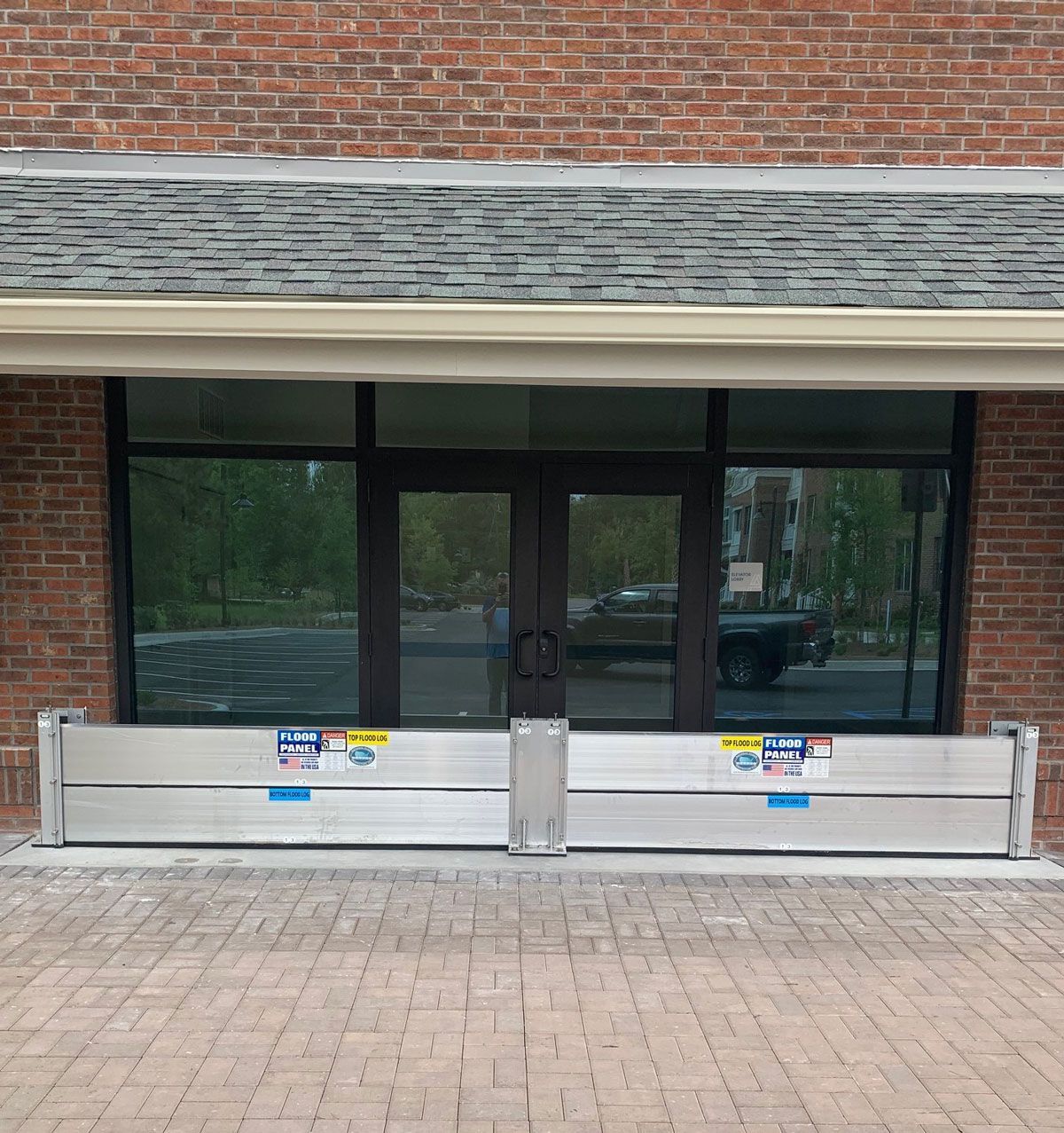 A brick building with a flood barrier in front of it