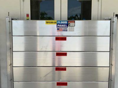 A stainless steel flood panel is sitting in front of a door.