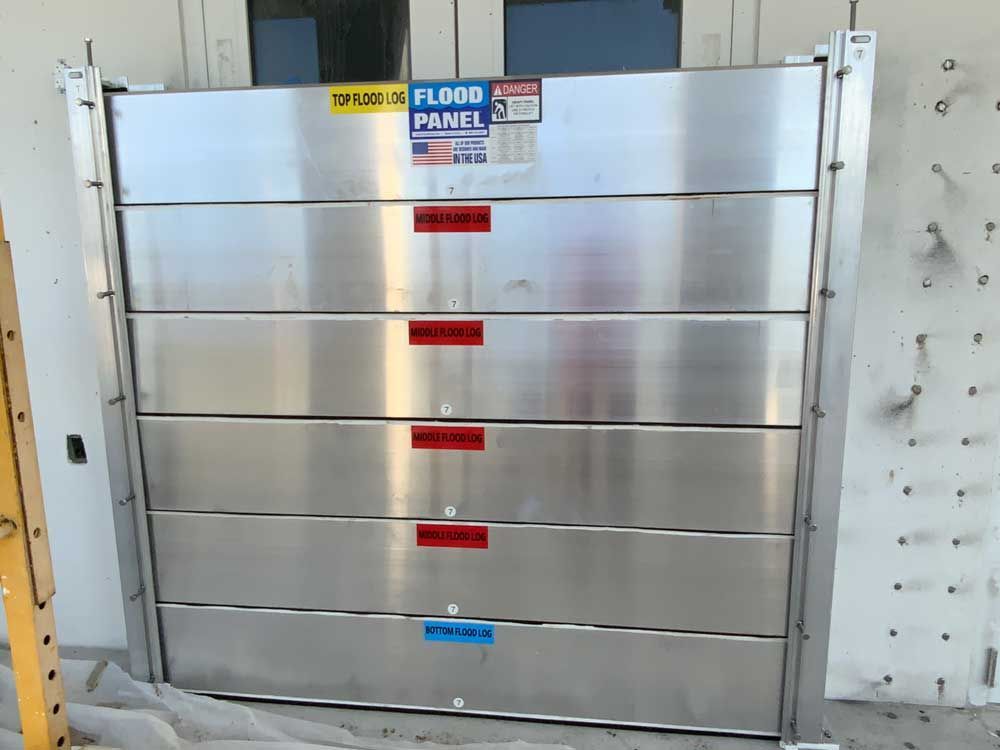 A stainless steel flood panel is sitting in front of a building