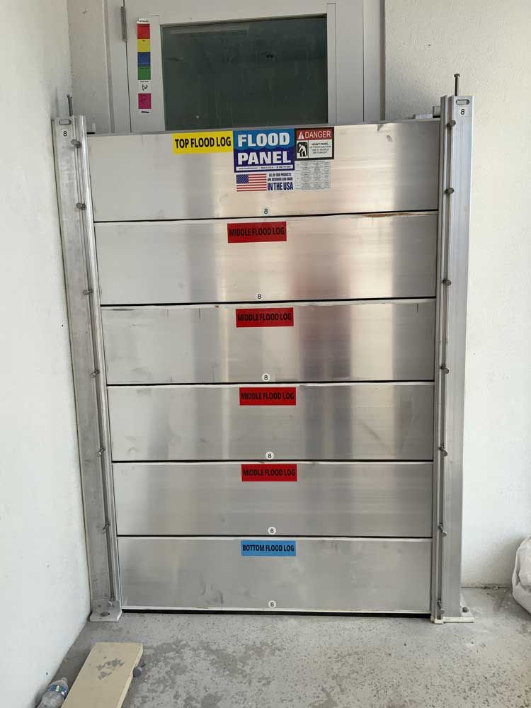 A stainless steel flood panel is sitting in a room next to a window.