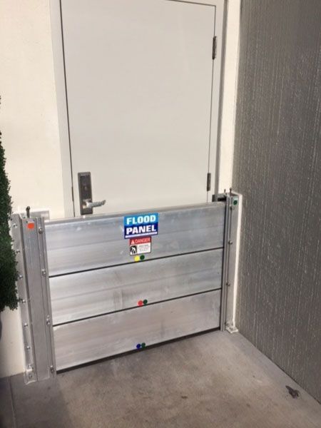 A door with a flood barrier in front of it.