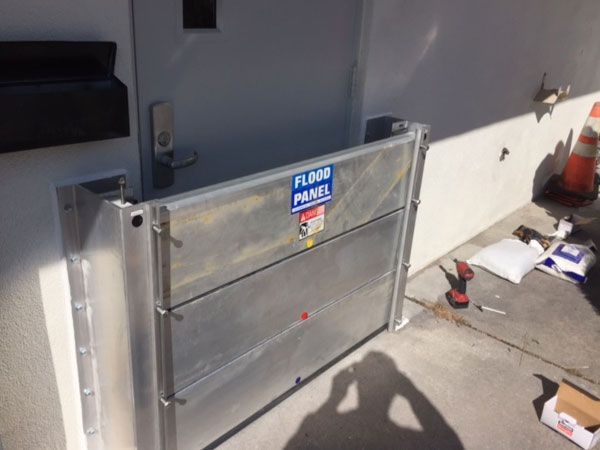 A flood panel is being installed in front of a door