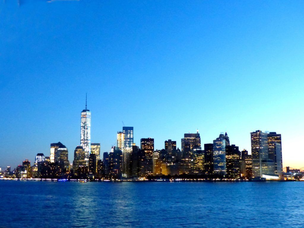 The skyline of new york city is seen from the water