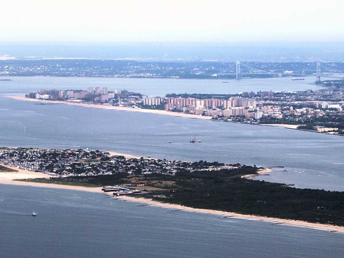 An aerial view of a body of water with a city in the background