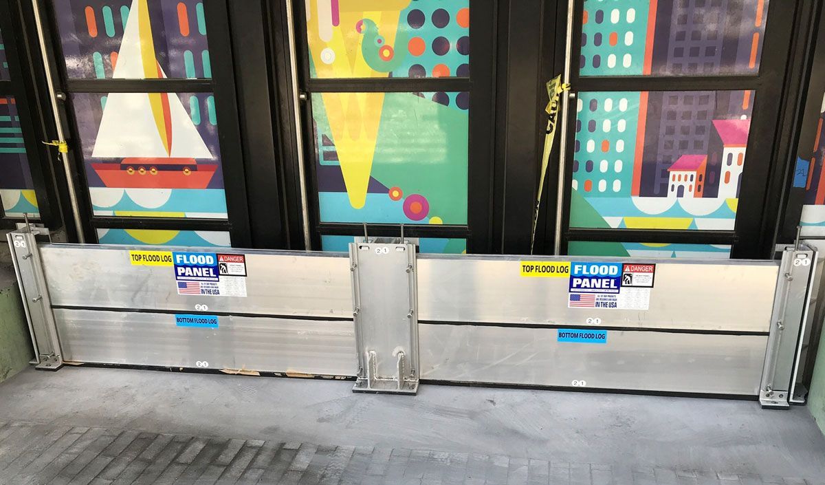 A flood barrier with a picture of a sailboat on it