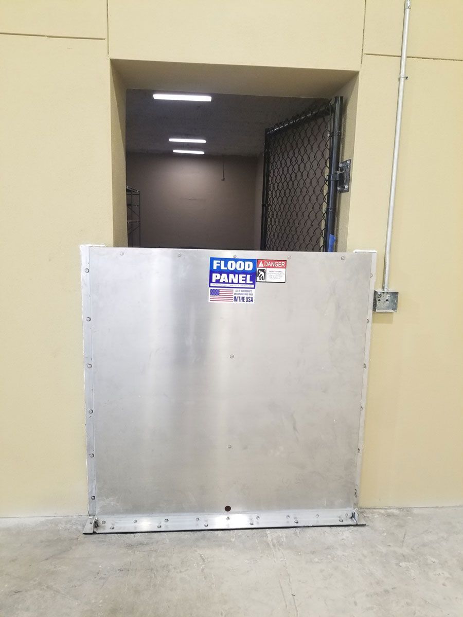A flood barrier is sitting in front of a door in a building.