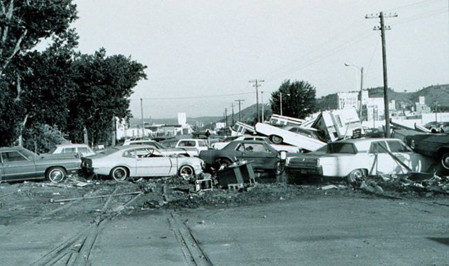 A black and white photo of a parking lot full of cars