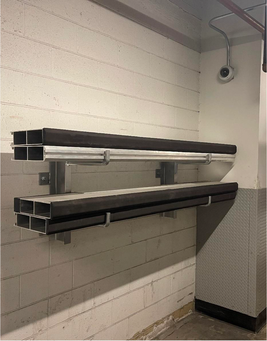 A room with a few shelves and a camera on the wall