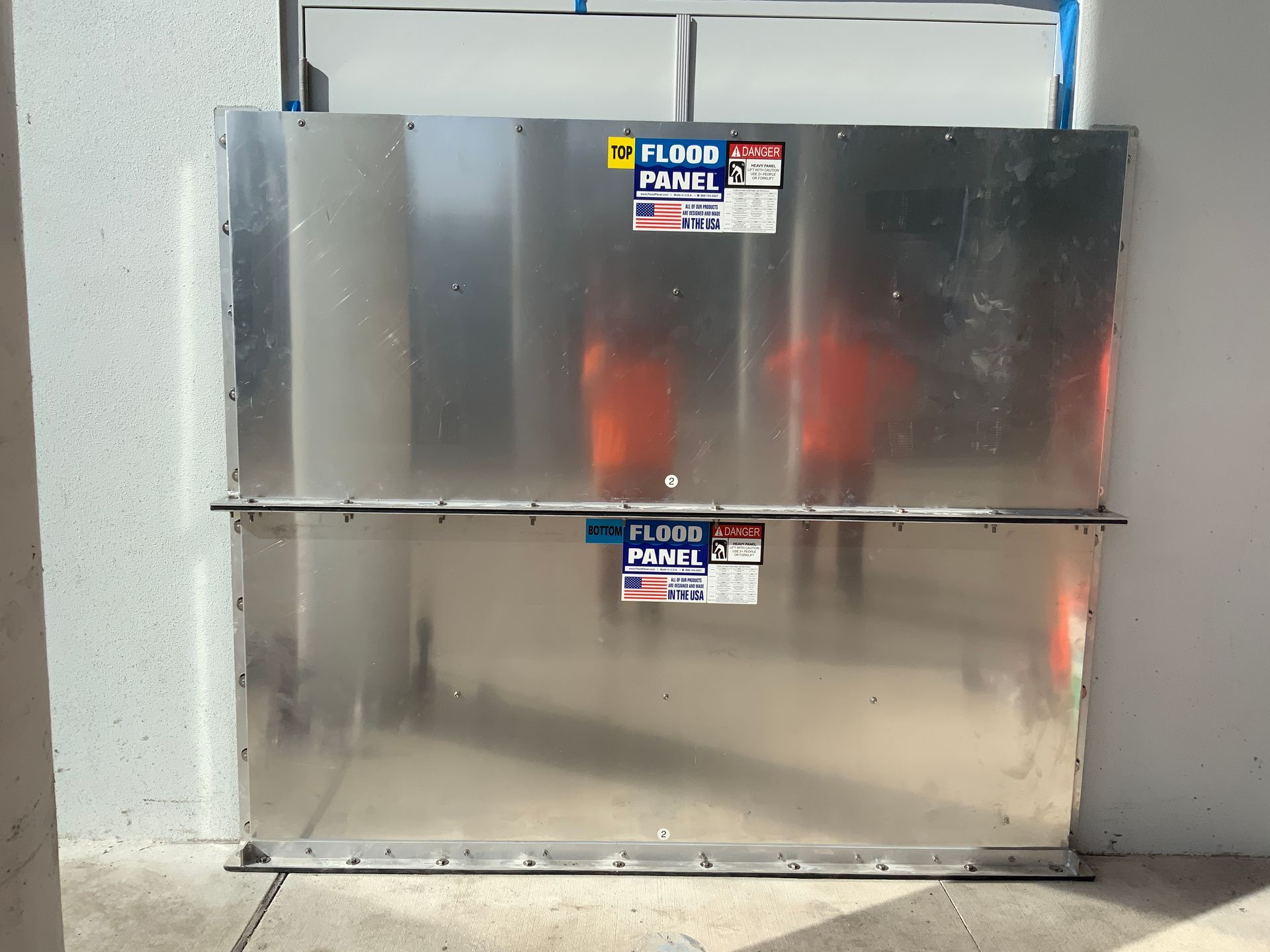 A metal wall with a sticker that says flood prime on it