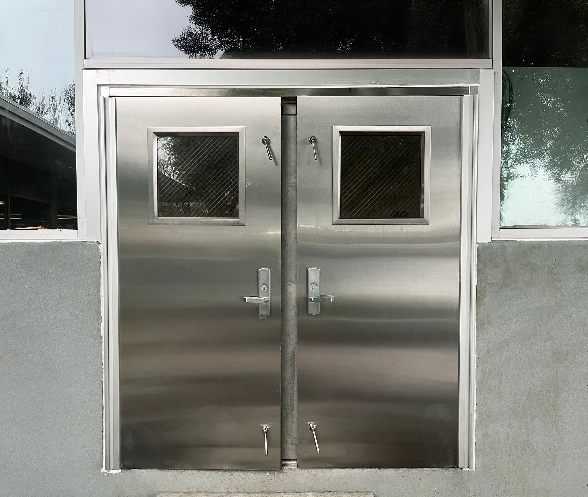 A building with stairs leading up to a door and a canopy over it.