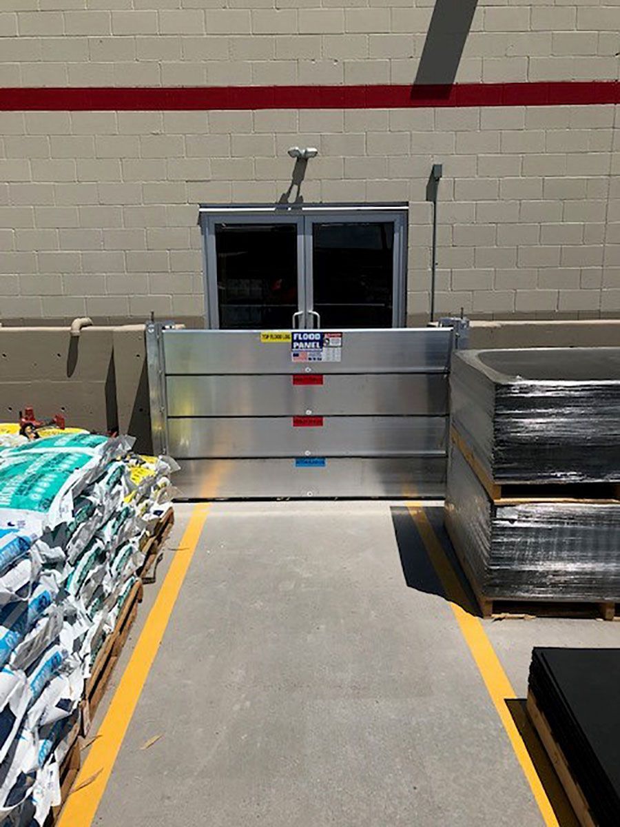 A warehouse with a flood barrier in front of it