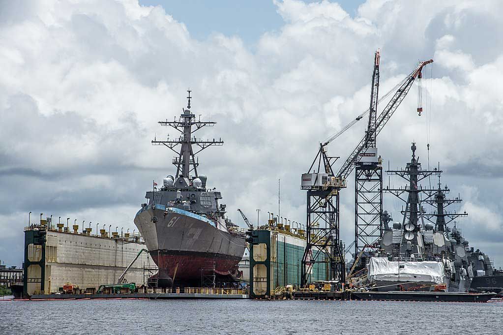 A large ship is being built in a shipyard in the water.