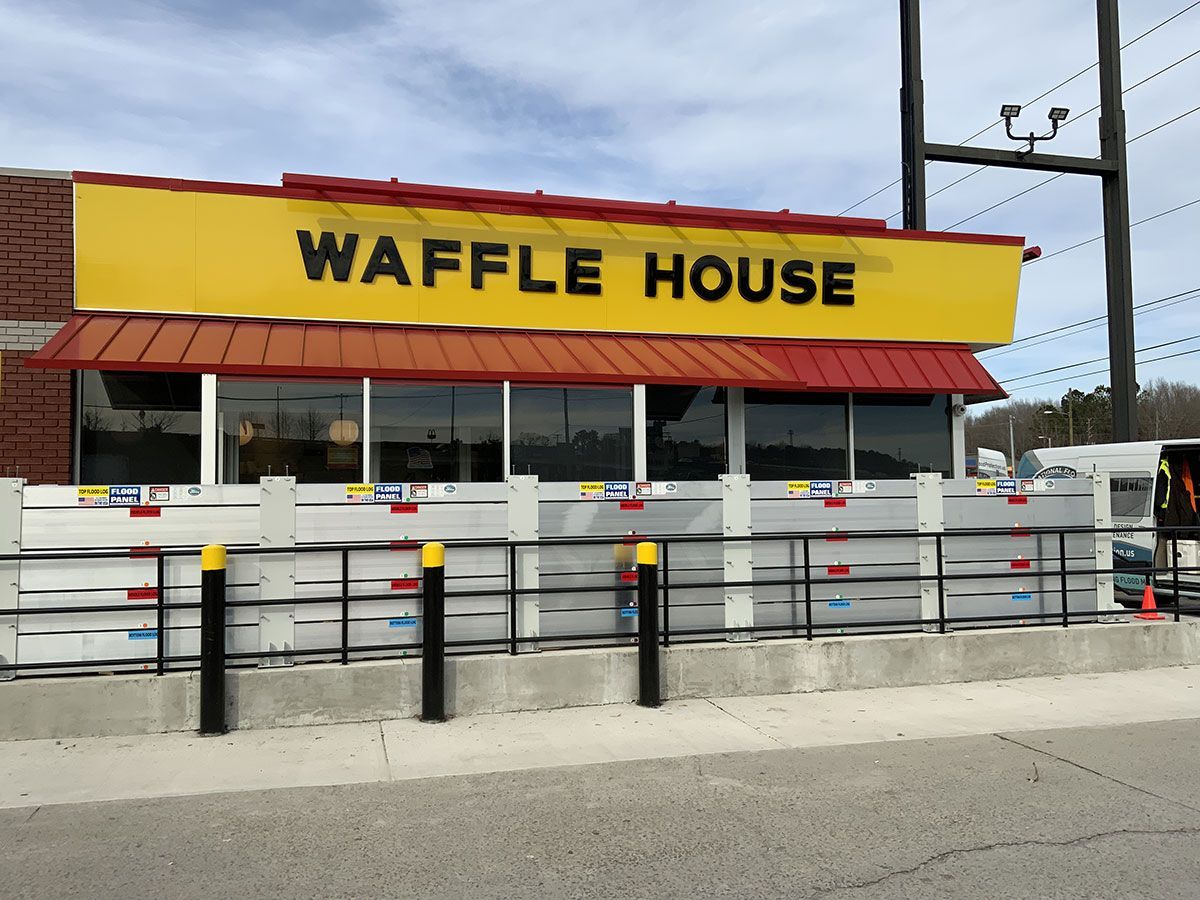 A waffle house restaurant with a yellow sign on the front