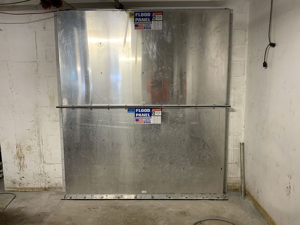 A large metal box is sitting in a room next to a wall.