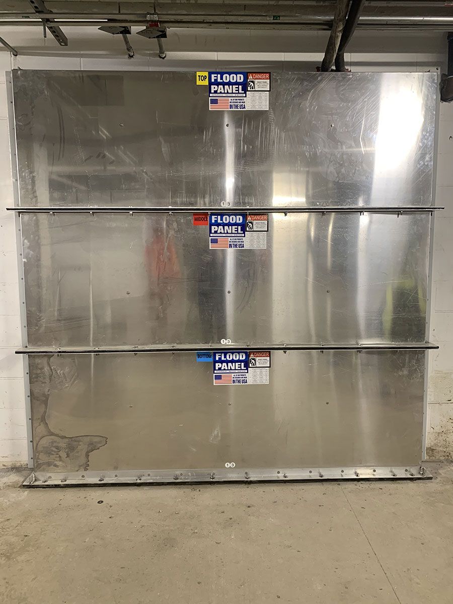A stainless steel wall with a sticker on it that says floor panels