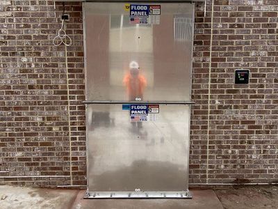 A man is standing in front of a flood panel