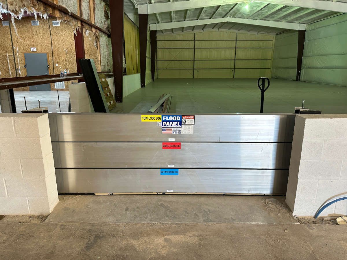 A flood barrier is sitting in the middle of a warehouse.