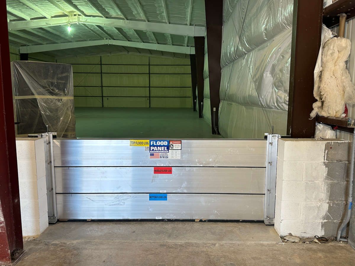 There is a flood barrier in the doorway of a building.