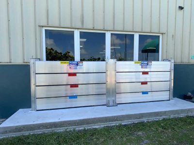 A flood barrier is sitting outside of a building next to a window.