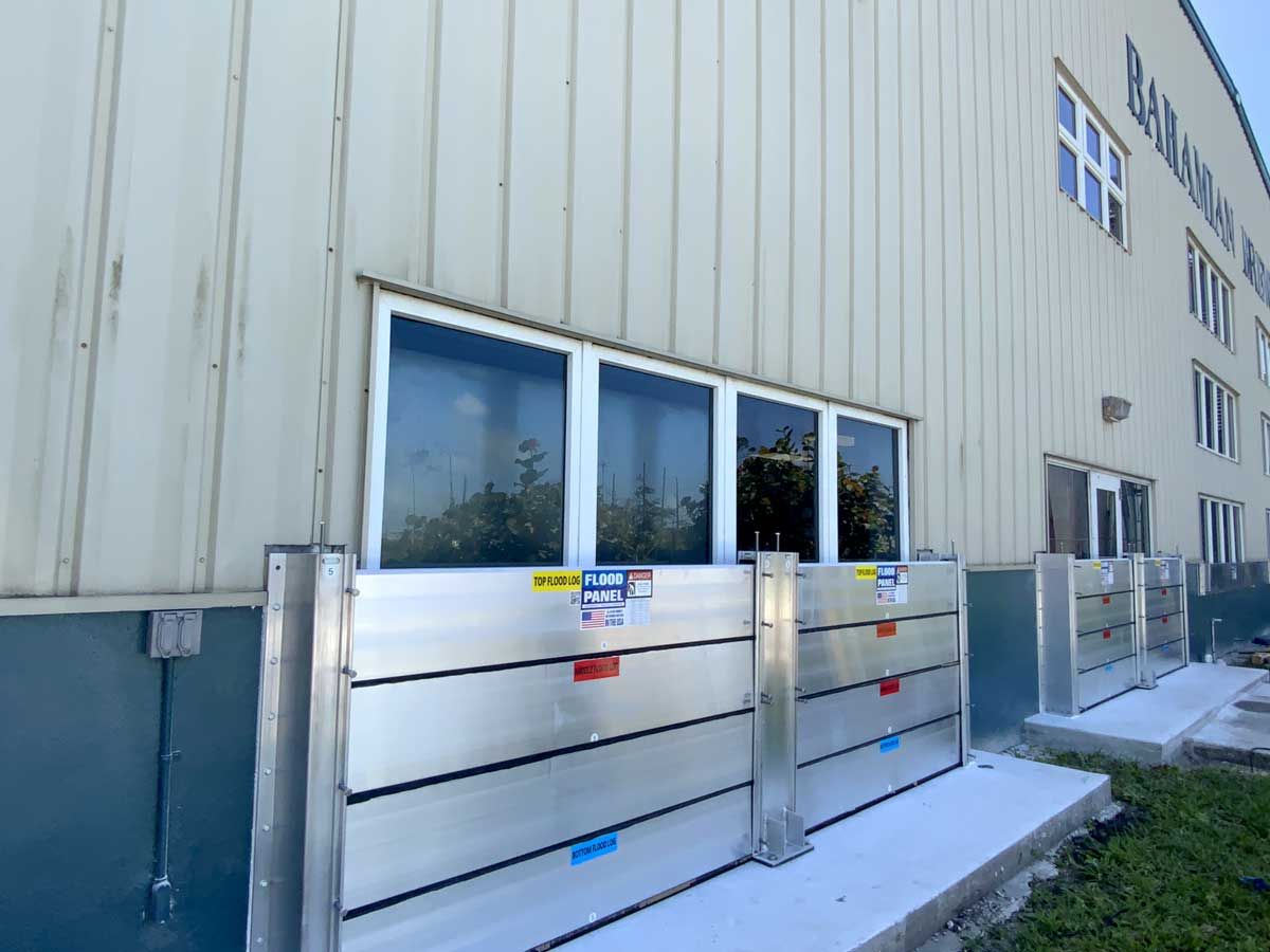 A building with a lot of windows and a flood barrier on the side of it.