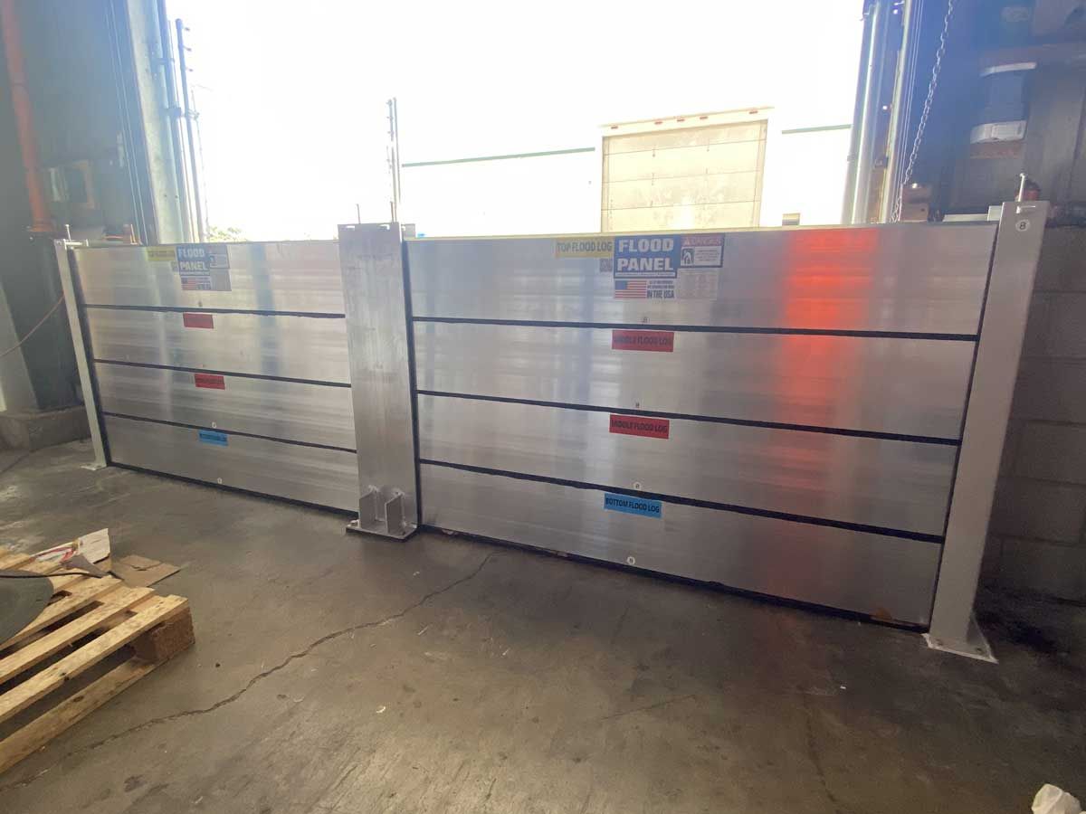 A pair of aluminum flood barriers in a warehouse.