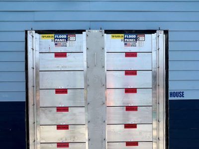 A flood panel is sitting on the side of a building