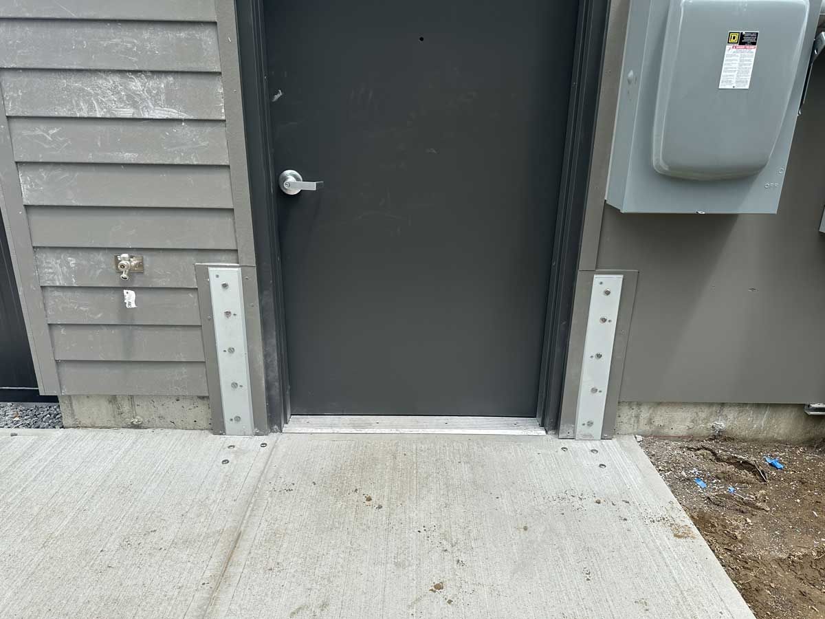 A black door is on the side of a building