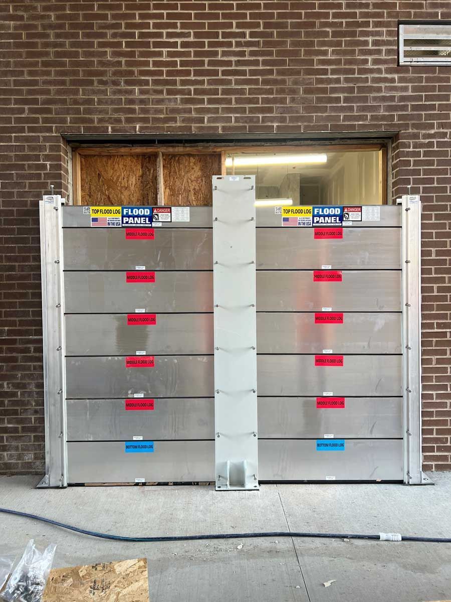 A brick building with a flood barrier on the side of it.