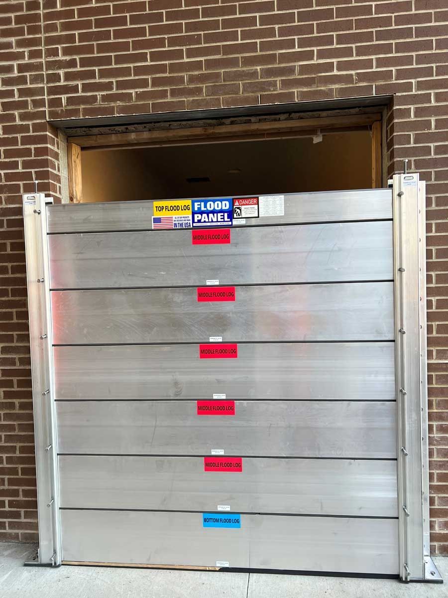 A brick building with a flood barrier in front of it