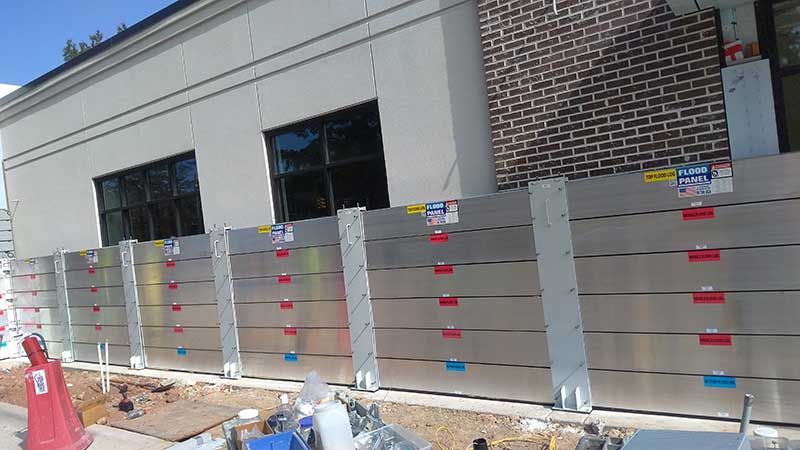 A building under construction with a fence in front of it.