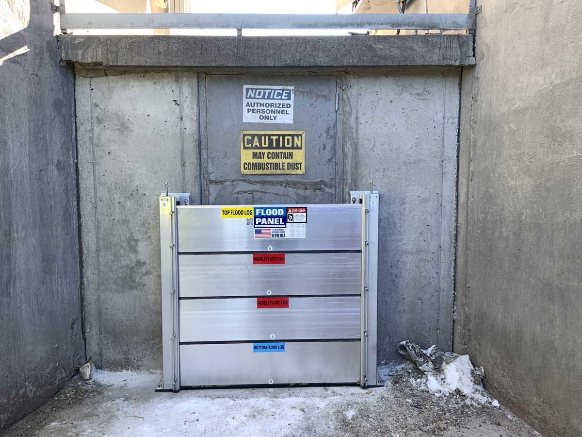 A concrete wall with a sign on it that says caution