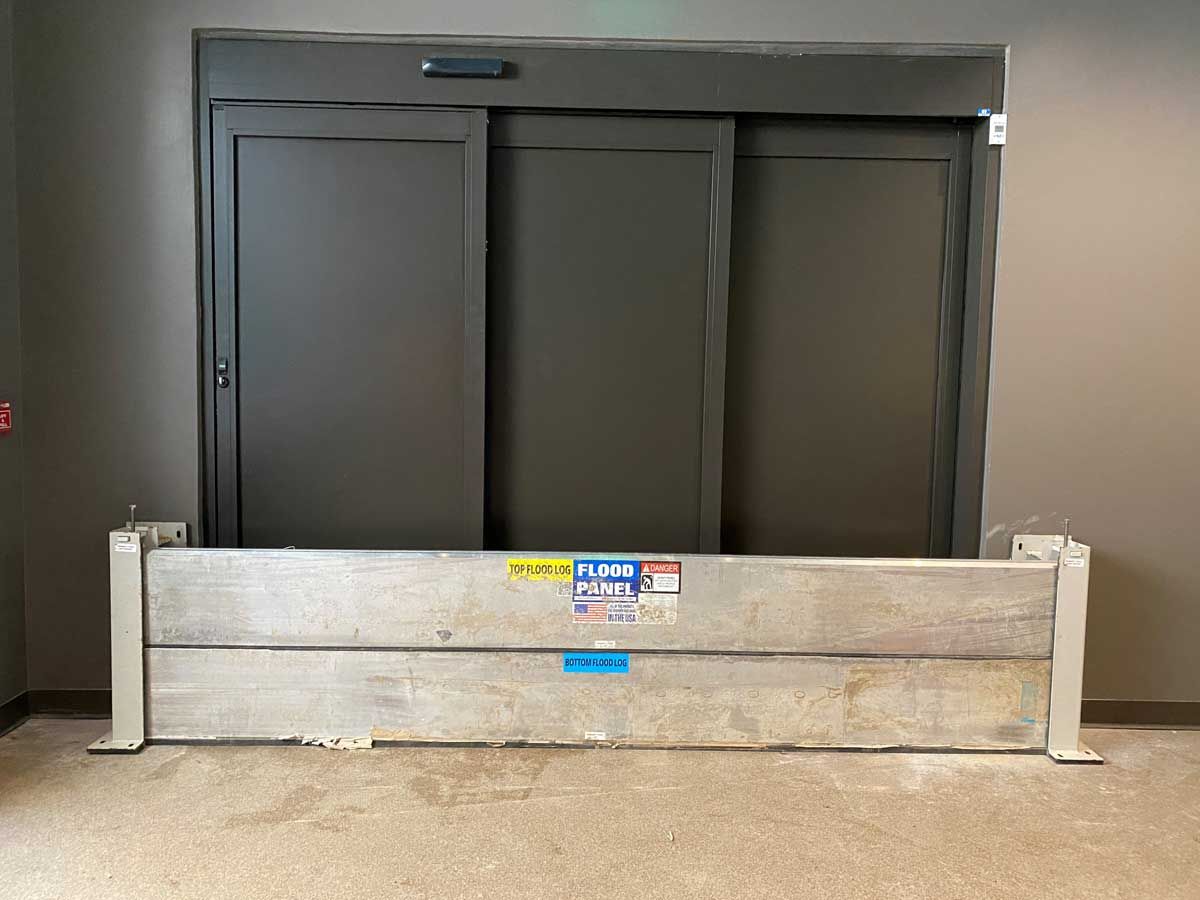 A flood barrier is sitting in front of a sliding glass door.