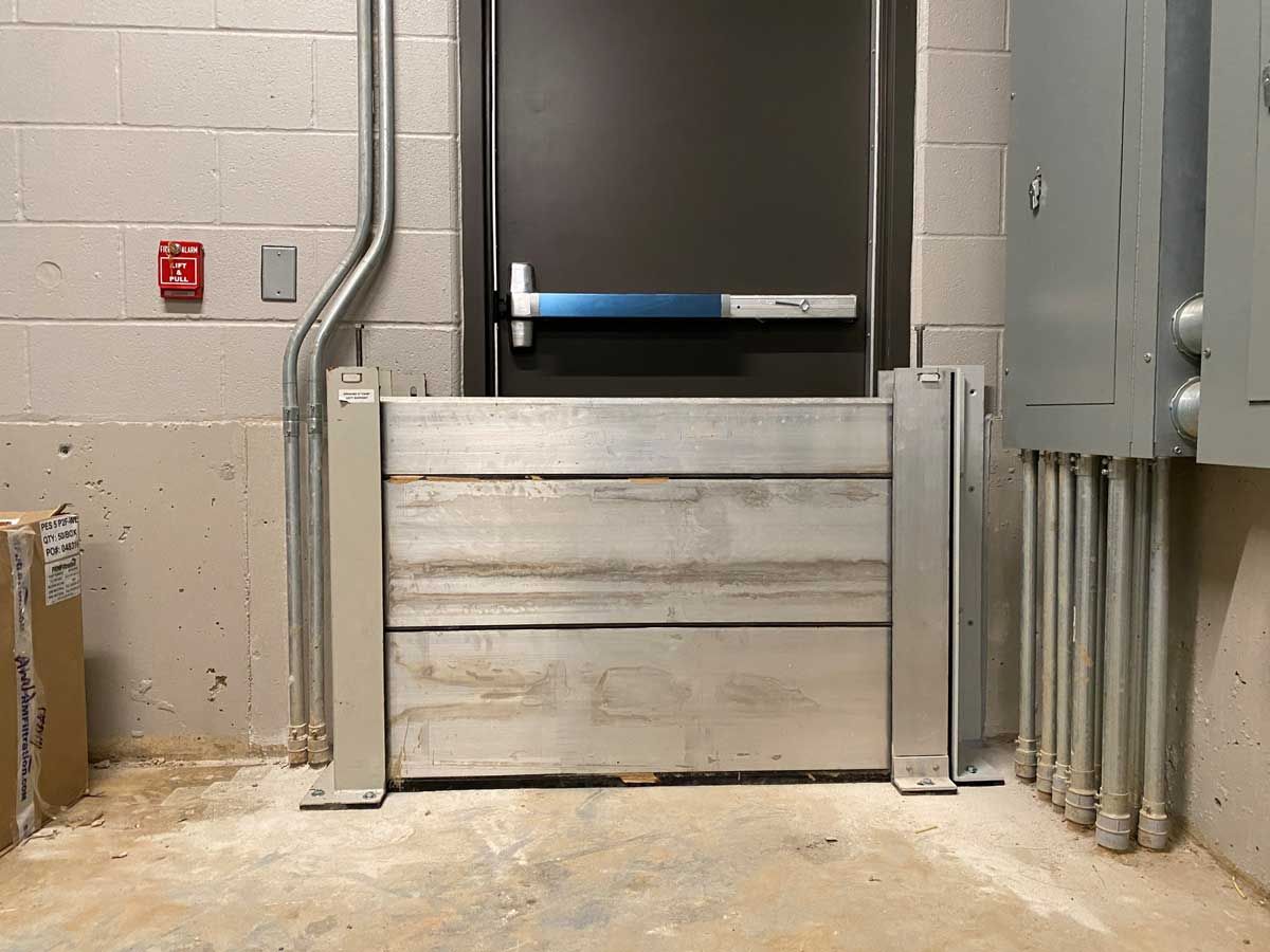 A room with a metal barrier in front of a door.