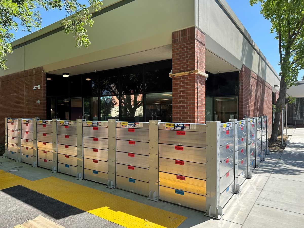 A building with a lot of flood barriers in front of it.