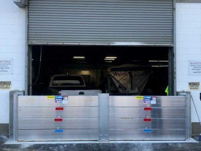 A garage door with a flood barrier in front of it.