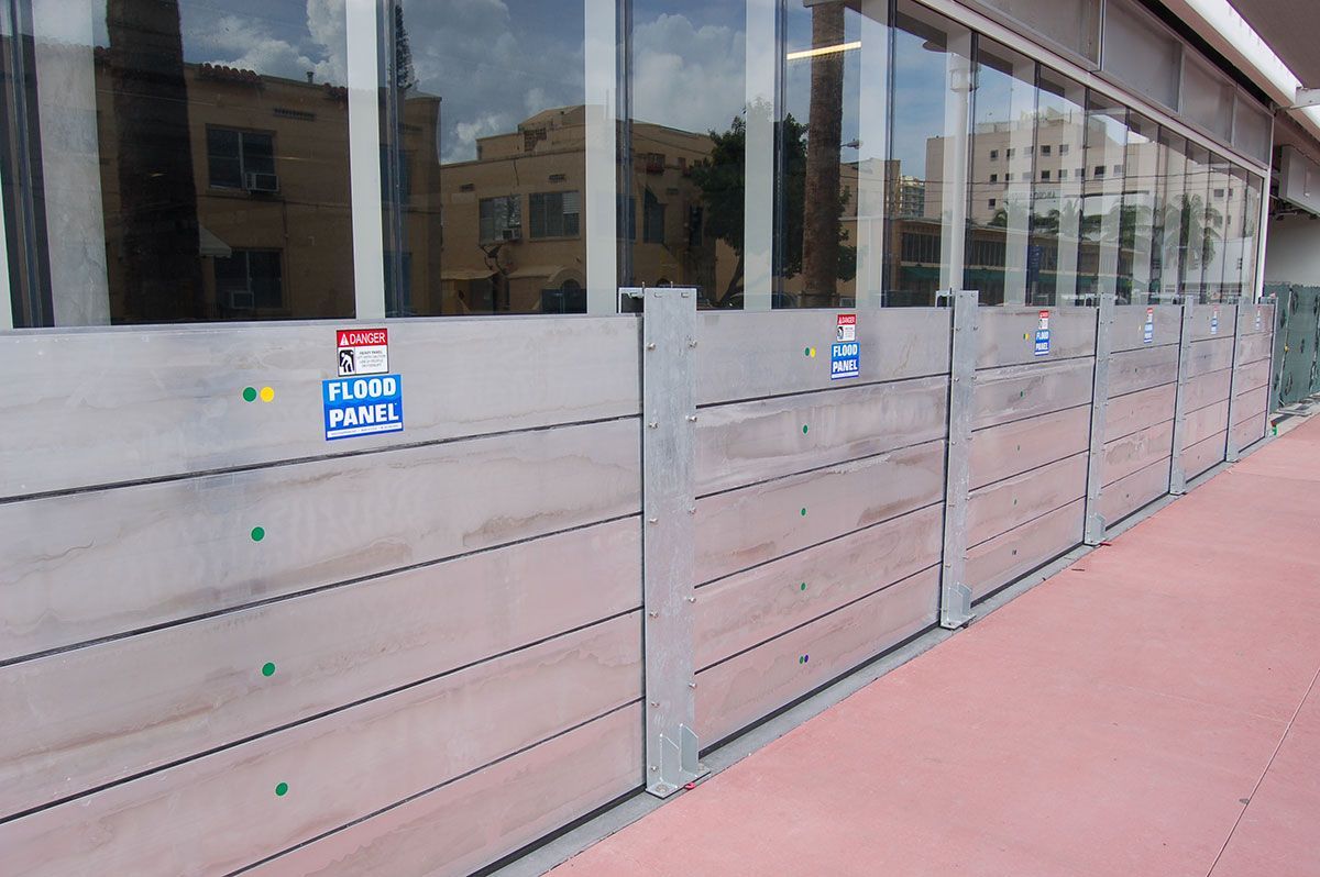 A row of wooden barriers are lined up in front of a building.