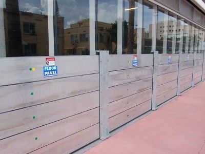 A row of wooden flood barriers on the side of a building.