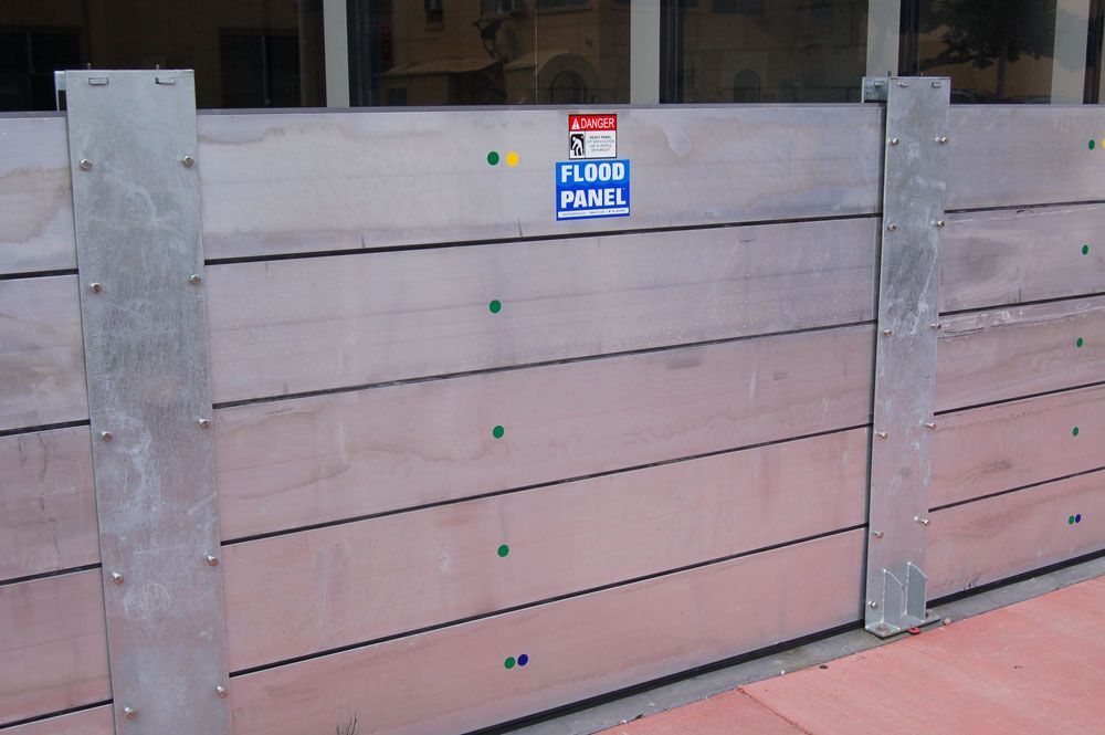 A wooden fence with a sign that says flood panel