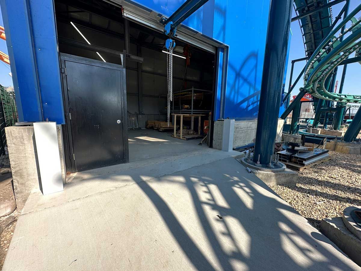 A roller coaster is being built in a warehouse.