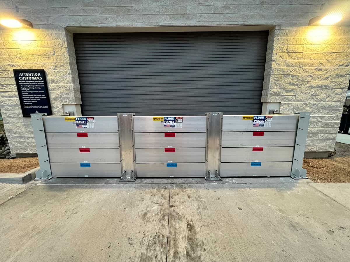 A flood barrier is sitting in front of a garage door.