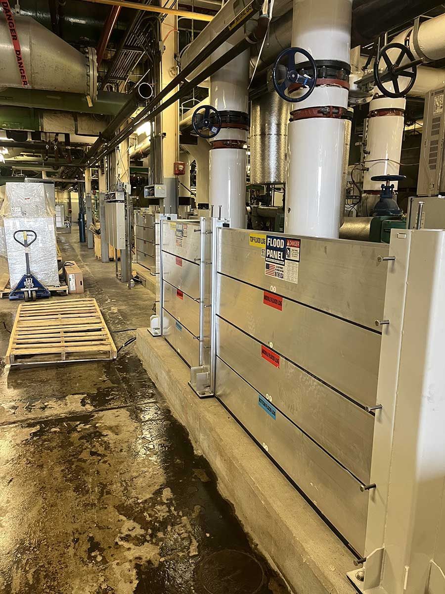 A warehouse with a lot of pipes and a pallet truck.