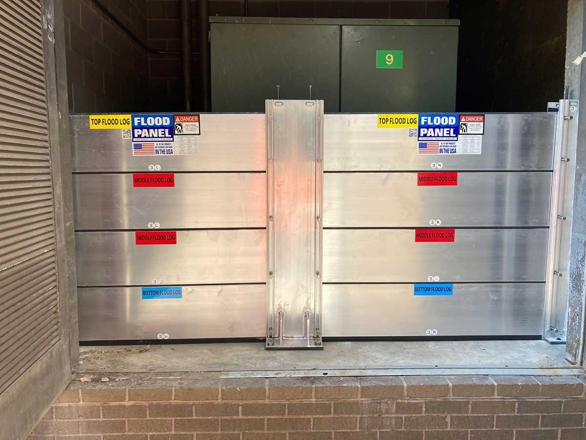 A flood panel is sitting in front of a brick wall.