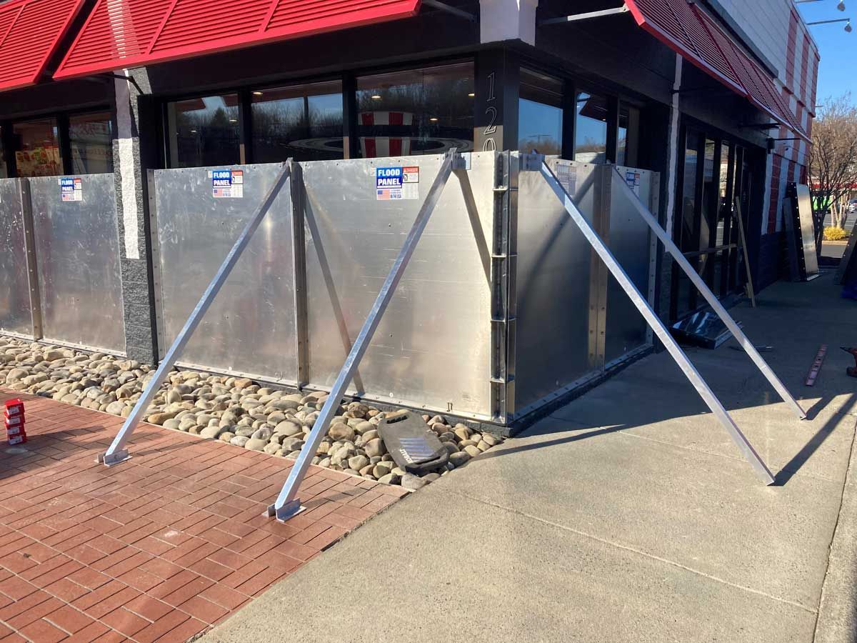 A metal fence is being built in front of a building.