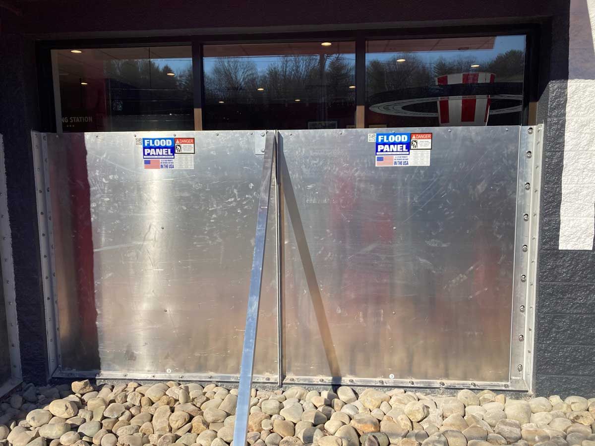 A metal barrier is sitting in front of a building.